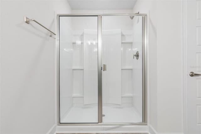 bathroom with a shower with door