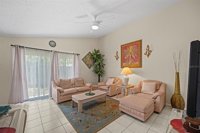 tiled living room with a textured ceiling, ceiling fan, and vaulted ceiling