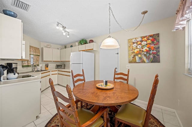 36 Coral Reef Ct N A/B, Unit A/B Palm Coast, FL 32137 - dining space featuring light tile patterned flooring and a textured ceiling