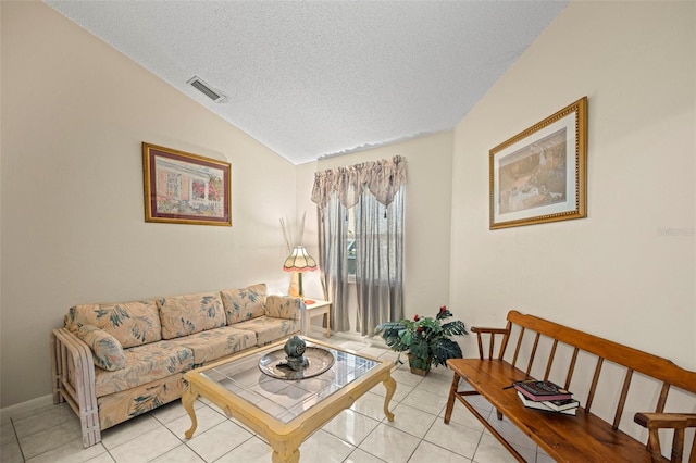 tiled living room with lofted ceiling and a textured ceiling