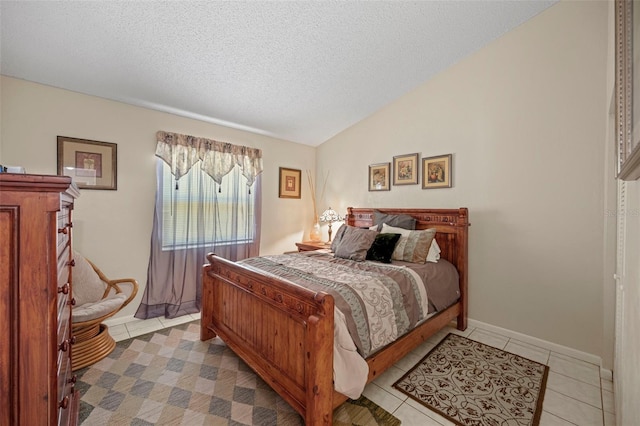 tiled bedroom with a textured ceiling and lofted ceiling