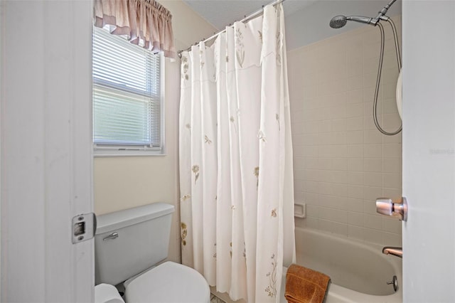 bathroom with toilet and shower / tub combo