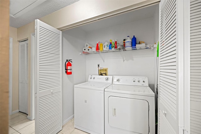 laundry room with light tile patterned flooring and separate washer and dryer