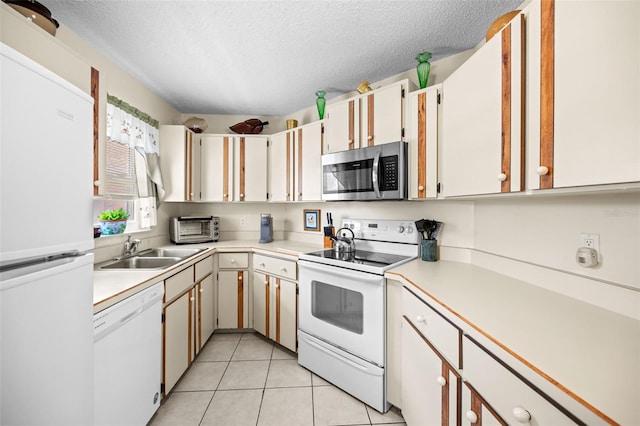 36 Coral Reef Ct N A/B, Unit A/B Palm Coast, FL 32137 - kitchen with white appliances, a textured ceiling, light countertops, and light tile patterned flooring