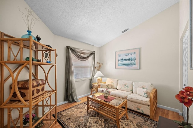 36 Coral Reef Ct N A/B, Unit A/B Palm Coast, FL 32137 - living area featuring a textured ceiling, lofted ceiling, and wood finished floors