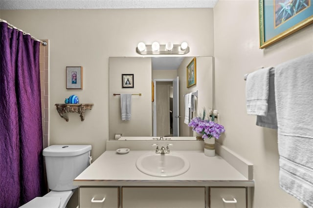 bathroom featuring vanity, toilet, and curtained shower