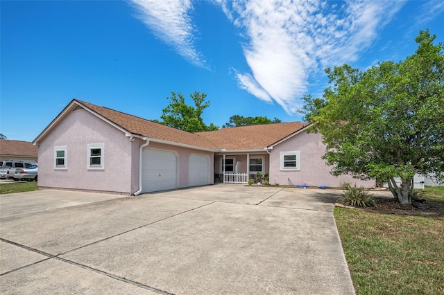 ranch-style house with covered porch and a garage