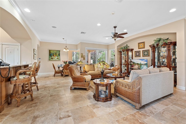 tiled living room with ceiling fan and crown molding