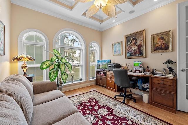 office area with light wood-style flooring, coffered ceiling, a ceiling fan, beamed ceiling, and crown molding