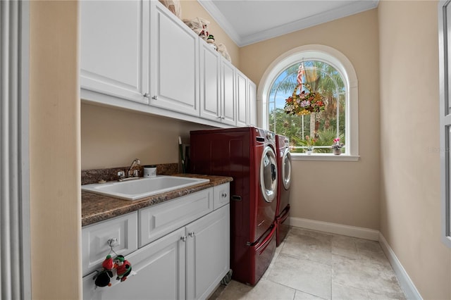 laundry area featuring a healthy amount of sunlight, washer and clothes dryer, sink, and light tile floors