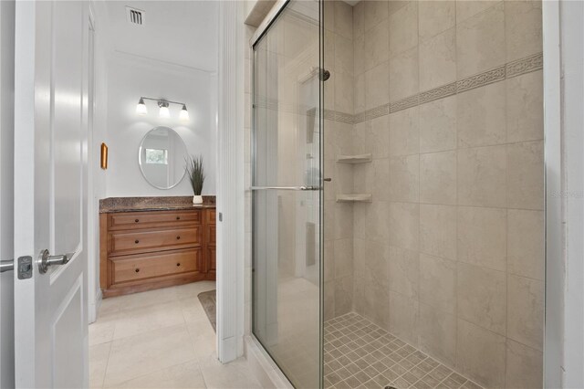 bathroom featuring an enclosed shower, ornamental molding, and tile flooring