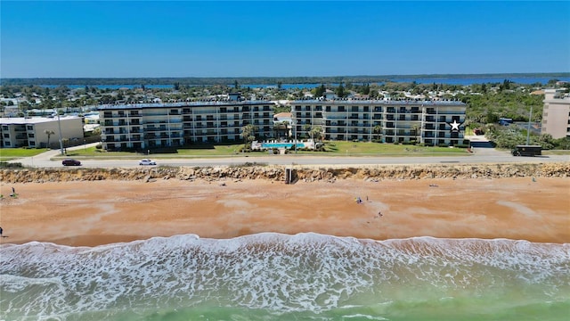 drone / aerial view with a water view and a view of the beach