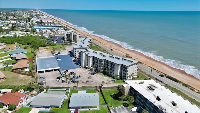 bird's eye view with a water view and a view of the beach