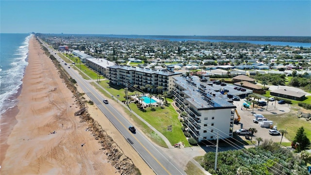 drone / aerial view with a water view and a view of the beach