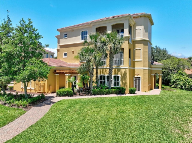 view of front of home featuring a front lawn and a balcony