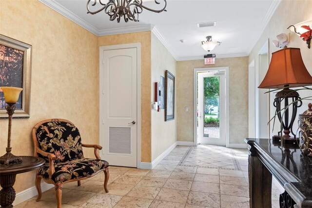 tiled foyer entrance featuring an inviting chandelier and crown molding