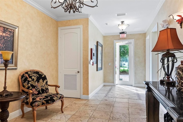 foyer with crown molding and a notable chandelier