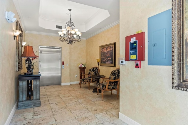 hall with elevator, electric panel, an inviting chandelier, a tray ceiling, and ornamental molding
