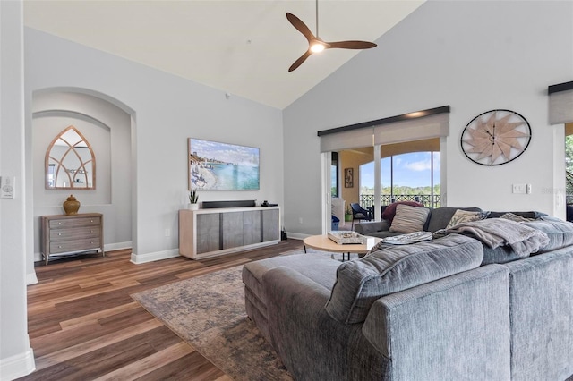 living room featuring ceiling fan, high vaulted ceiling, and dark hardwood / wood-style flooring