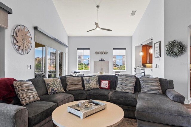 living room with high vaulted ceiling and ceiling fan