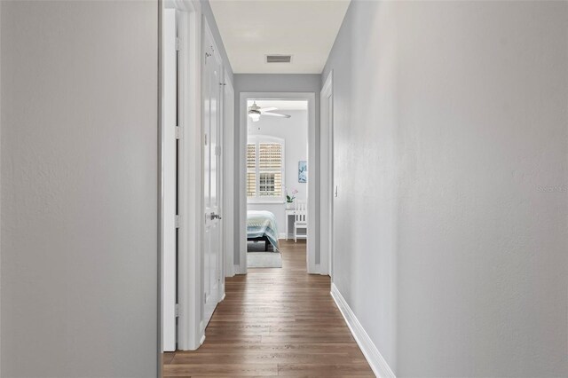 hall with wood-type flooring