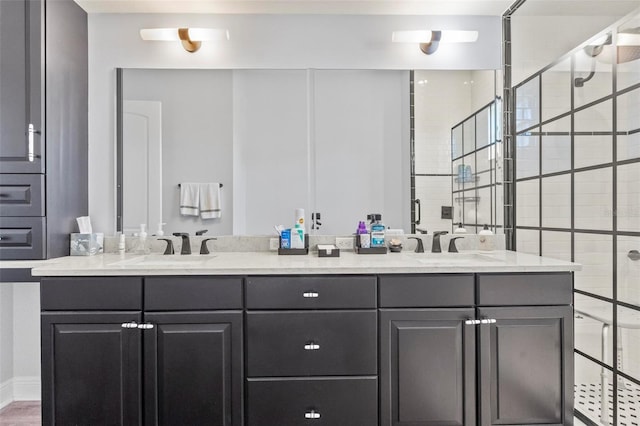 bathroom featuring a tile shower and vanity