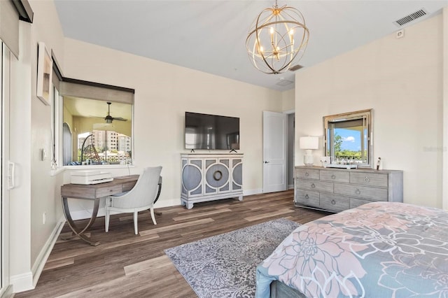 bedroom featuring dark wood-type flooring, a chandelier, and multiple windows