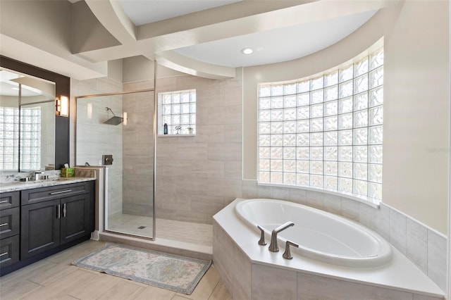 bathroom with shower with separate bathtub, oversized vanity, and tile floors