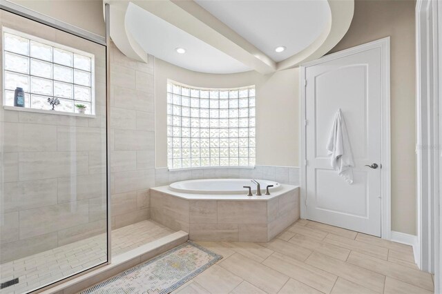 bathroom featuring tile floors and plus walk in shower