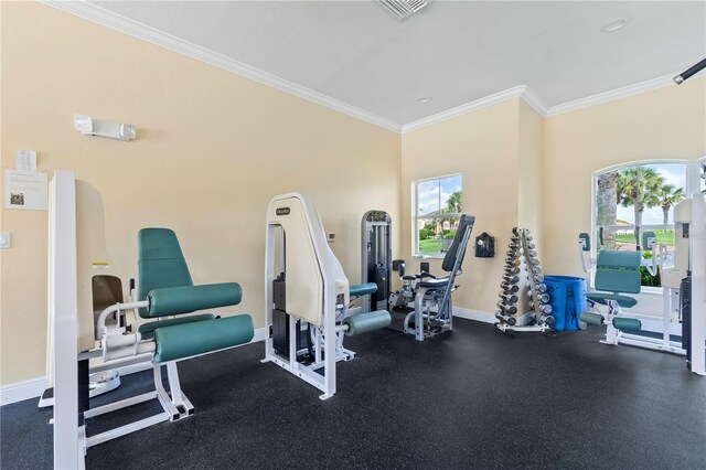 gym with a healthy amount of sunlight and crown molding