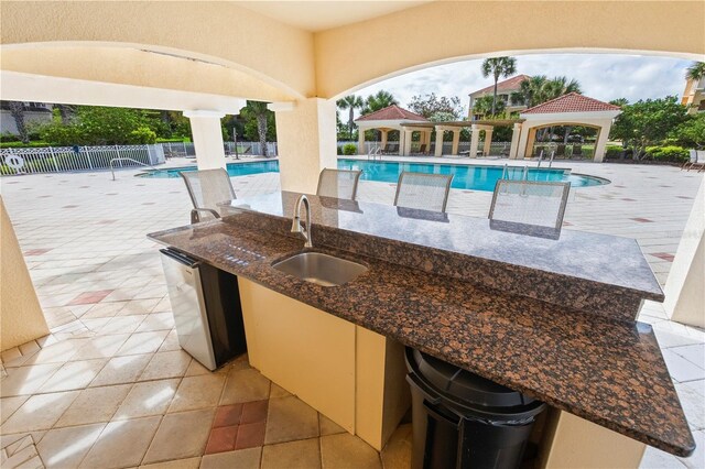 view of pool with sink, a patio area, and a gazebo