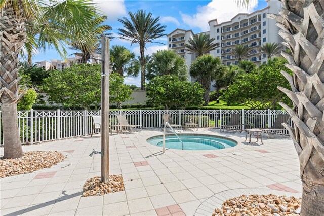 view of swimming pool with a patio and a hot tub