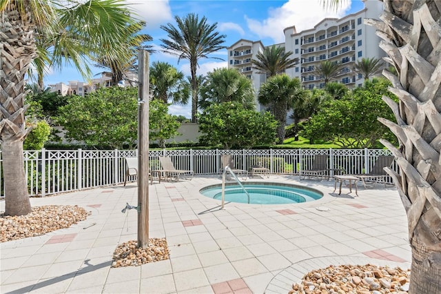 view of swimming pool with a patio area and a community hot tub