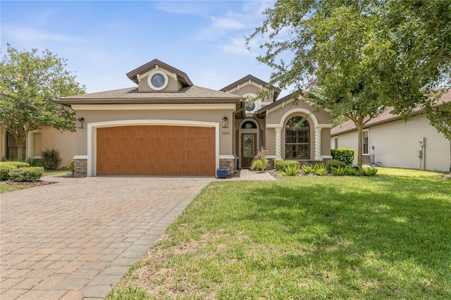 view of front of house featuring a garage and a front lawn