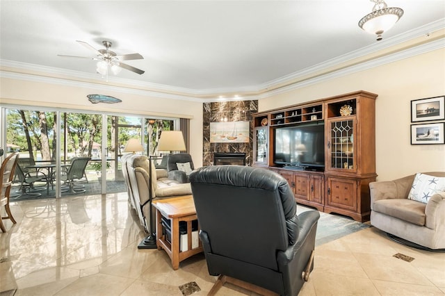 living room featuring ceiling fan, ornamental molding, and a fireplace