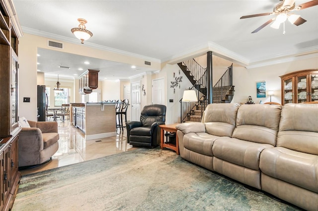 living room featuring ceiling fan and crown molding