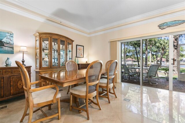 dining room featuring ornamental molding and light tile patterned floors