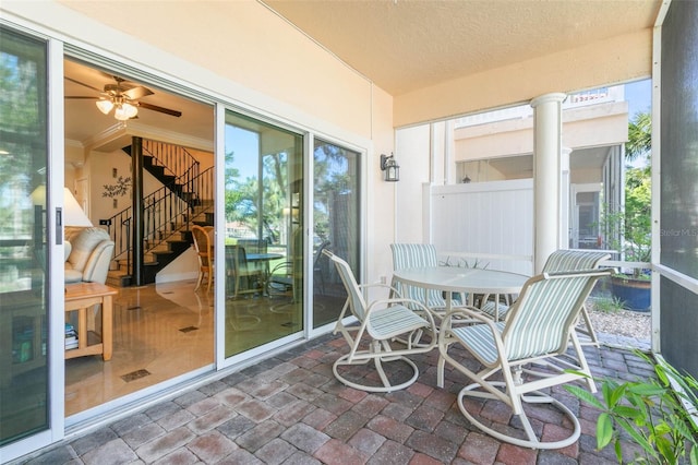 sunroom featuring ceiling fan