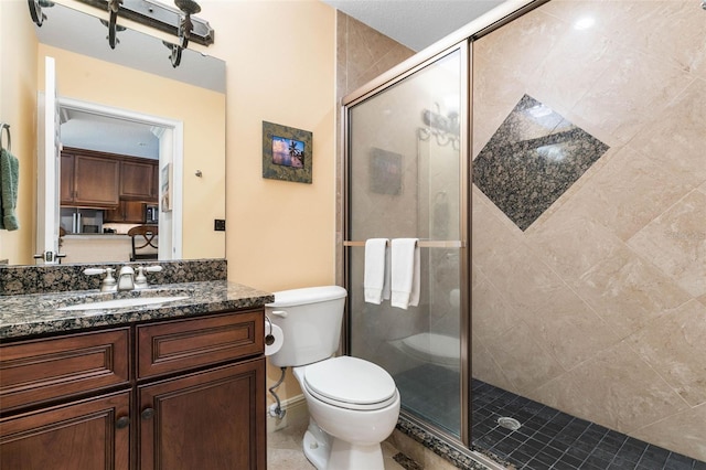 bathroom with vanity, toilet, and walk in shower