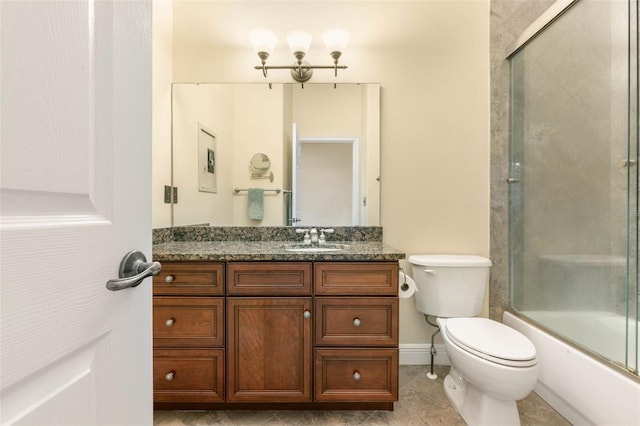 full bathroom featuring shower / bath combination with glass door, tile patterned flooring, vanity, and toilet