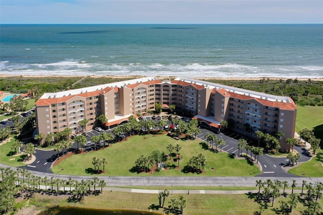 drone / aerial view featuring a water view and a beach view