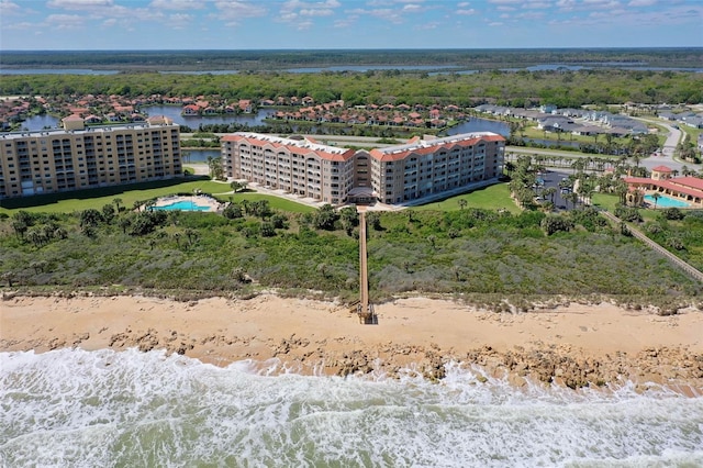 aerial view with a water view and a beach view