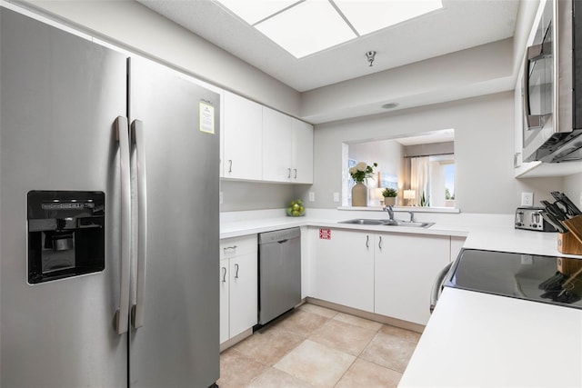 kitchen featuring sink, white cabinetry, and stainless steel appliances