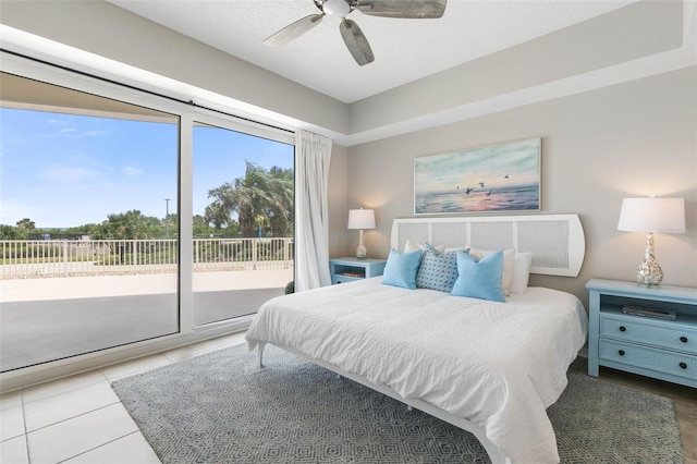 tiled bedroom with ceiling fan and access to exterior