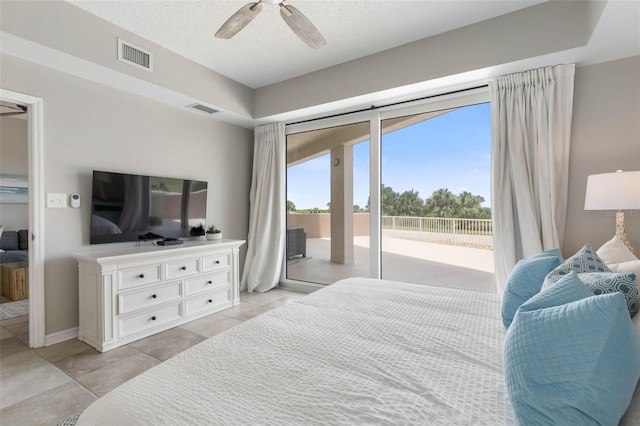 bedroom with a textured ceiling, access to outside, and ceiling fan