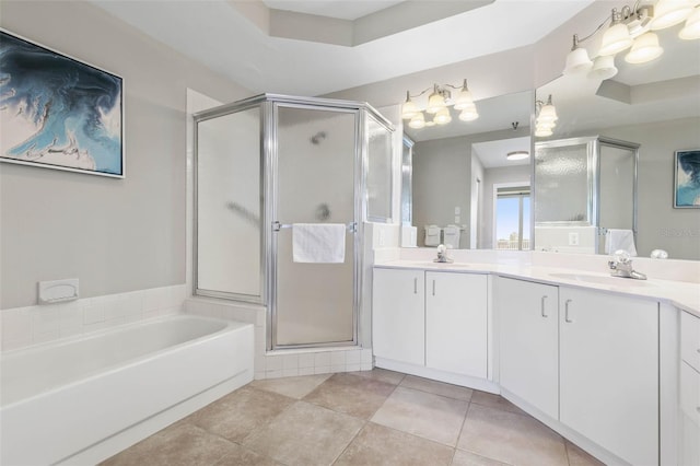 bathroom featuring a tray ceiling, tile patterned floors, vanity, and independent shower and bath