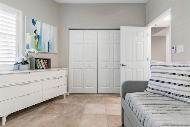 tiled bedroom with a closet