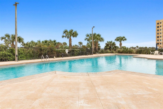 view of swimming pool featuring a patio area