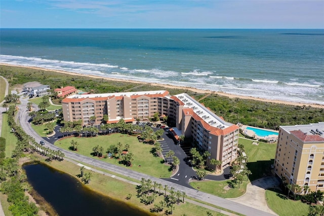 bird's eye view featuring a water view and a beach view