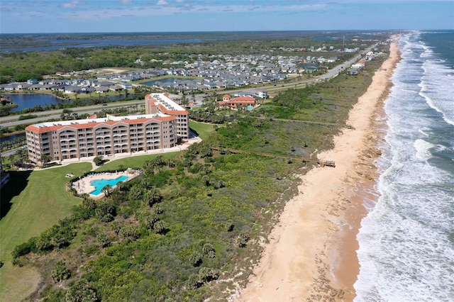 drone / aerial view with a water view and a view of the beach